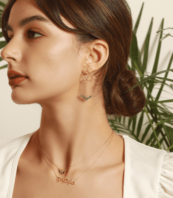 model wearing an earrings and two necklaces inspired from the Lebanese culture